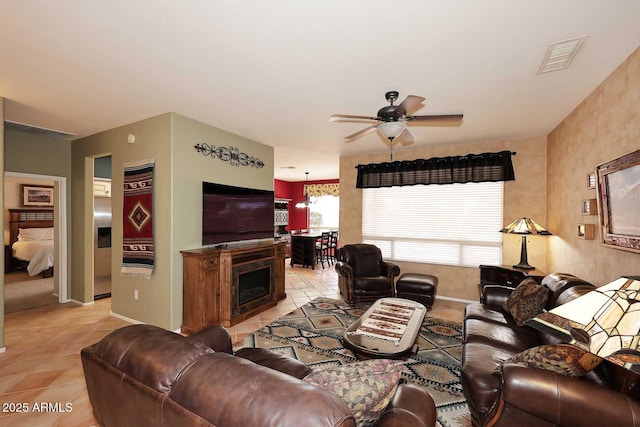 17630 N Somerset Dr, Surprise, AZ 85374 - living room with light tile patterned floors, ceiling fan, and baseboards