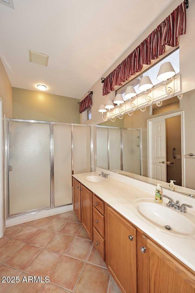 17630 N Somerset Dr, Surprise, AZ 85374 - bathroom featuring a shower stall, double vanity, and tile patterned floors
