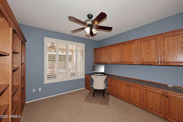 17630 N Somerset Dr, Surprise, AZ 85374 - unfurnished office featuring built in desk, a ceiling fan, light carpet, and baseboards