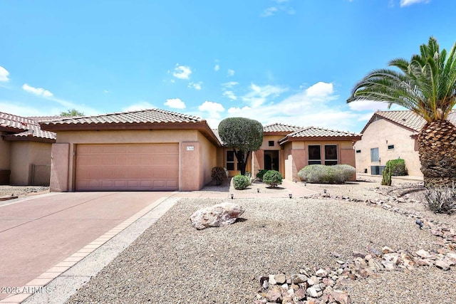 17630 N Somerset Dr, Surprise, AZ 85374 - mediterranean / spanish home with an attached garage, driveway, stucco siding, and a tile roof