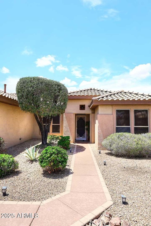 17630 N Somerset Dr, Surprise, AZ 85374 - view of exterior entry with a tile roof and stucco siding