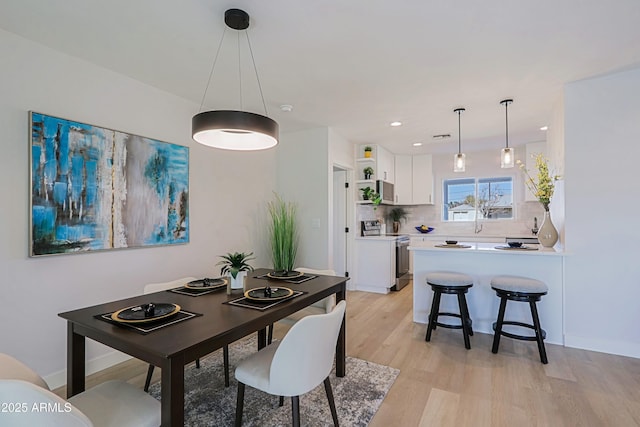 dining space with light hardwood / wood-style flooring