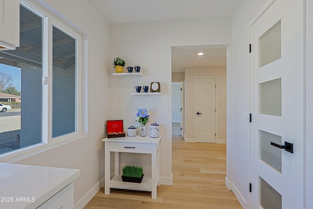 hall with light wood-type flooring