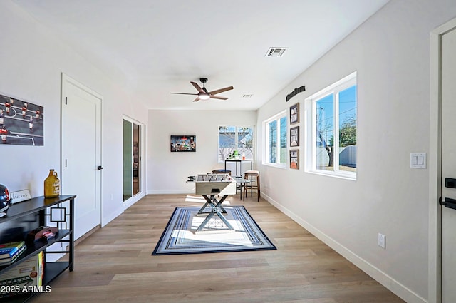 dining room with light hardwood / wood-style flooring and ceiling fan