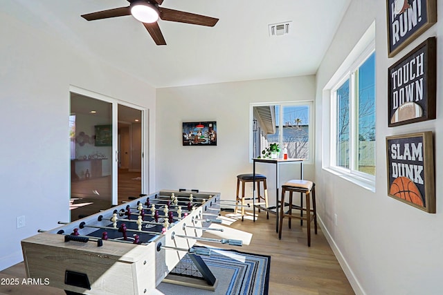 game room with hardwood / wood-style floors and ceiling fan