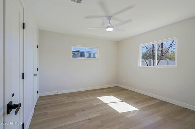 empty room with ceiling fan and light hardwood / wood-style floors