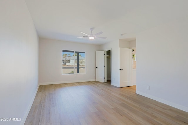 empty room with light hardwood / wood-style floors and ceiling fan