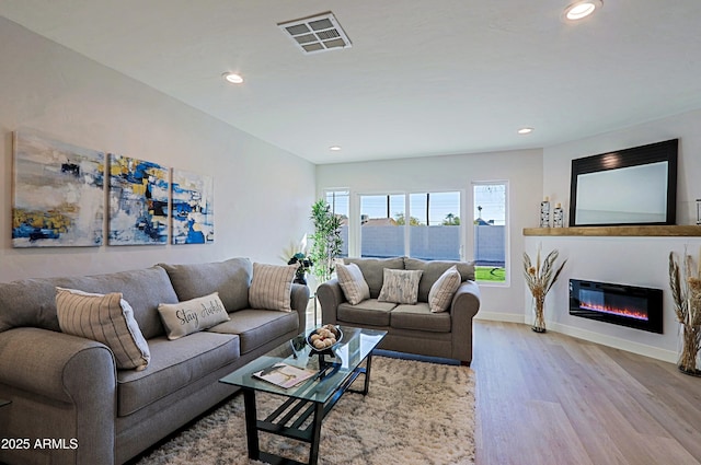 living room with light hardwood / wood-style flooring