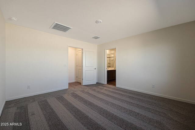551 S W Virginia Ave, Florence, AZ 85132 - unfurnished bedroom featuring baseboards and dark carpet