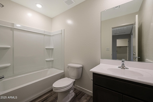 551 S W Virginia Ave, Florence, AZ 85132 - full bathroom with wood finished floors, toilet, baseboards, vanity, and a textured wall