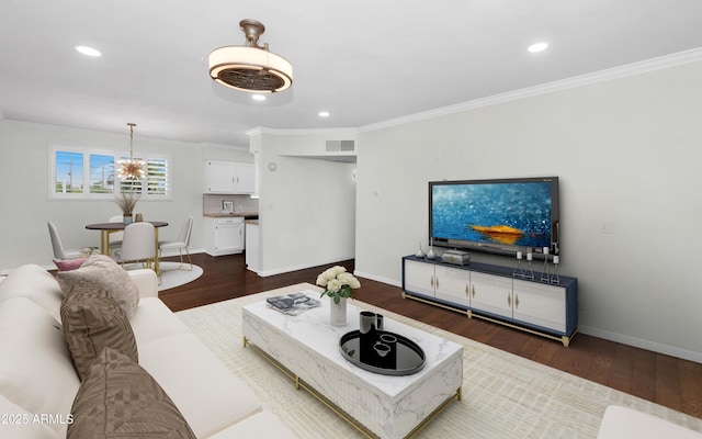 1111 E Turney Ave Unit 28, Phoenix, AZ 85014 - living area featuring dark wood-style flooring, crown molding, recessed lighting, baseboards, and a chandelier