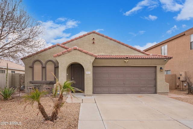 mediterranean / spanish-style home with a garage