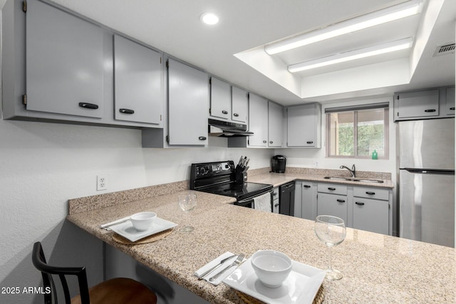 4150 E Cactus Rd Unit 205, Phoenix, AZ 85032 - kitchen with black range with electric stovetop, freestanding refrigerator, under cabinet range hood, gray cabinetry, and light countertops