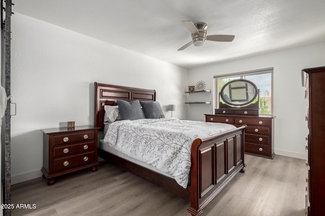 4150 E Cactus Rd Unit 205, Phoenix, AZ 85032 - bedroom featuring light wood-style floors and a ceiling fan