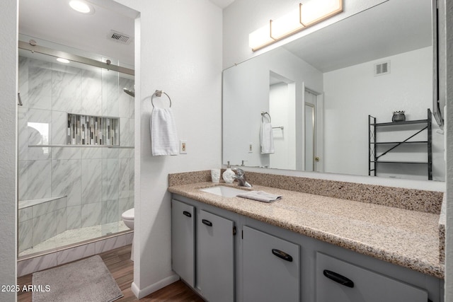 4150 E Cactus Rd Unit 205, Phoenix, AZ 85032 - full bathroom with vanity, a shower stall, and wood finished floors