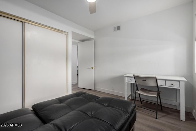 4150 E Cactus Rd Unit 205, Phoenix, AZ 85032 - bedroom with wood finished floors, a closet, and a ceiling fan