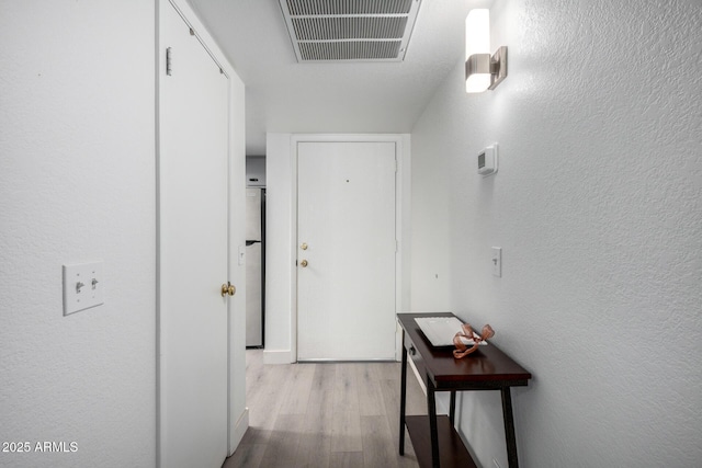 4150 E Cactus Rd Unit 205, Phoenix, AZ 85032 - hallway featuring wood finished floors and a textured wall