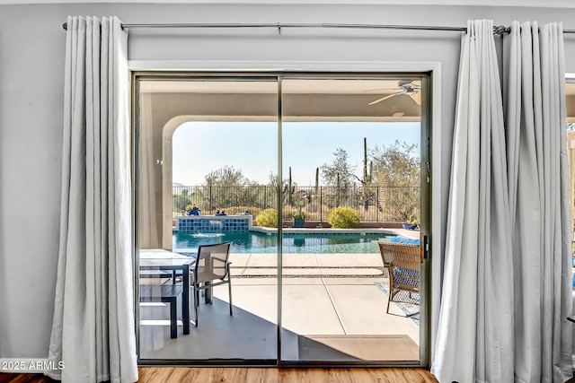 doorway to outside featuring hardwood / wood-style floors, ceiling fan, and a healthy amount of sunlight