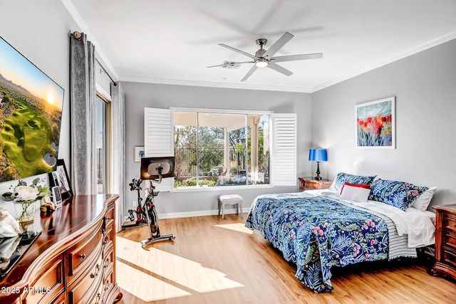 bedroom featuring ceiling fan, crown molding, baseboards, and wood finished floors