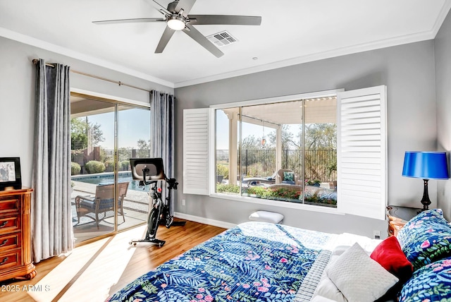 bedroom with access to exterior, ceiling fan, multiple windows, and hardwood / wood-style flooring