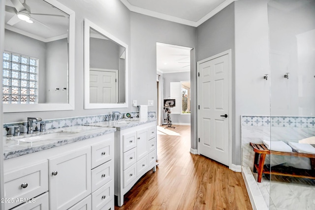 bathroom with vanity, ornamental molding, wood finished floors, and a ceiling fan