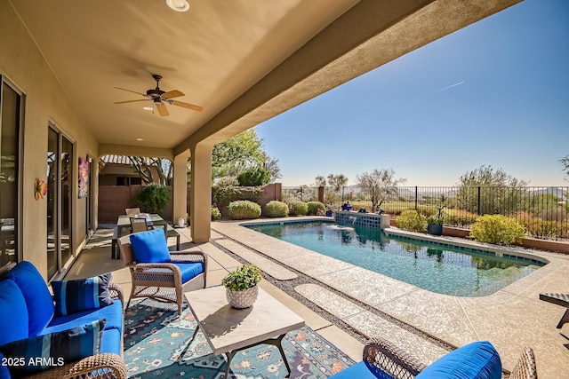 view of swimming pool featuring a fenced in pool, a ceiling fan, a fenced backyard, a patio area, and outdoor lounge area