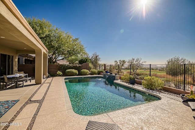 view of swimming pool featuring a fenced in pool, a fenced backyard, and a patio