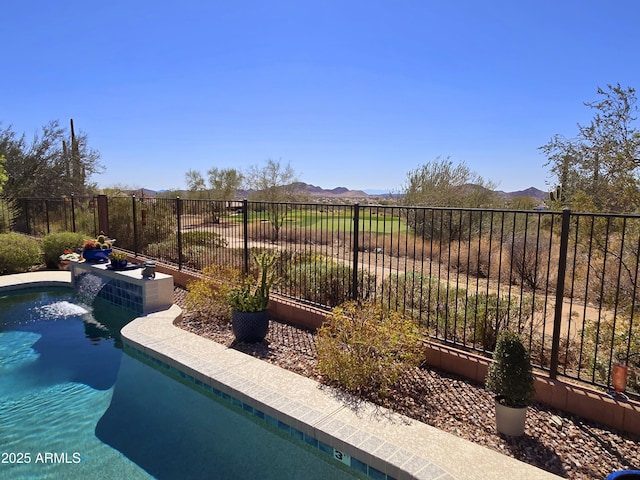 view of pool featuring a fenced in pool, a mountain view, and fence