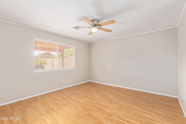 spare room featuring light hardwood / wood-style flooring, ornamental molding, and ceiling fan