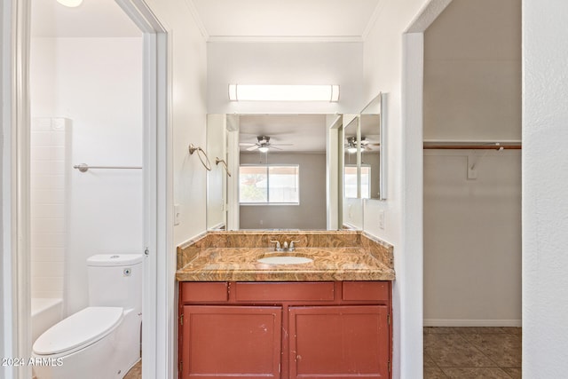 bathroom featuring tile patterned floors, toilet, ornamental molding, vanity, and ceiling fan