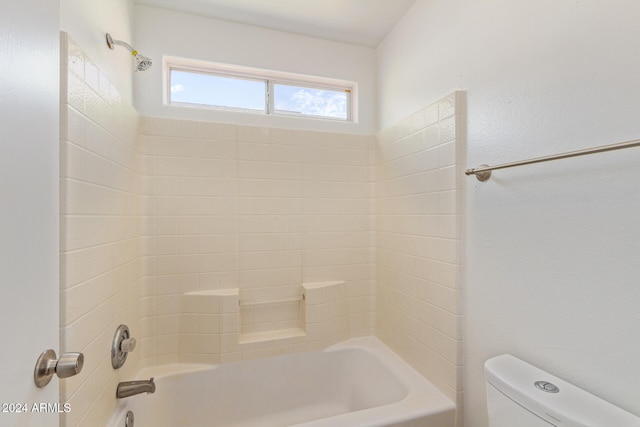 bathroom with toilet and  shower combination