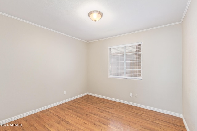 unfurnished room featuring light hardwood / wood-style flooring and ornamental molding