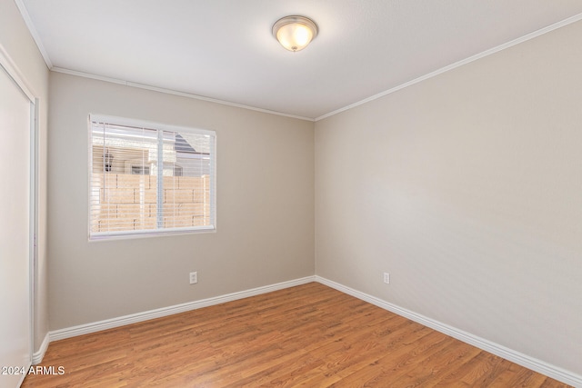 unfurnished room with crown molding and hardwood / wood-style flooring