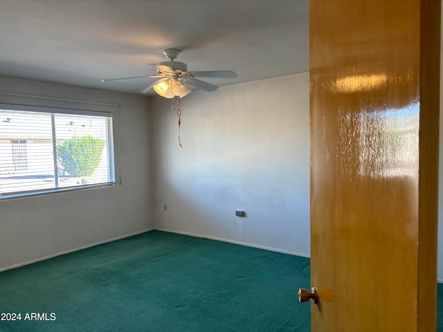 carpeted empty room featuring ceiling fan