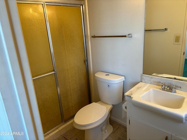 bathroom with vanity, toilet, and walk in shower