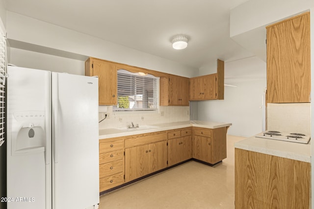 kitchen featuring decorative backsplash, sink, and white appliances