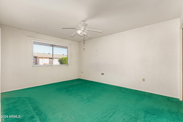 unfurnished room featuring ceiling fan and carpet floors