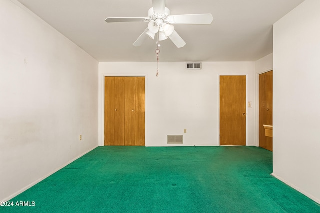 spare room featuring ceiling fan and carpet