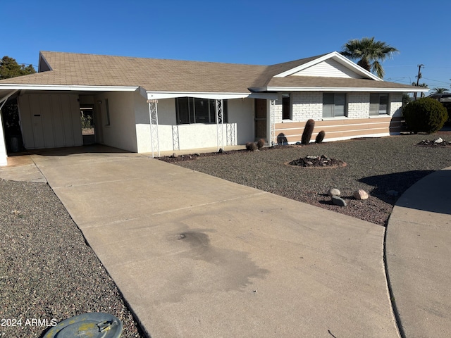 single story home featuring a carport