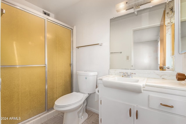 bathroom with hardwood / wood-style flooring, vanity, toilet, and walk in shower