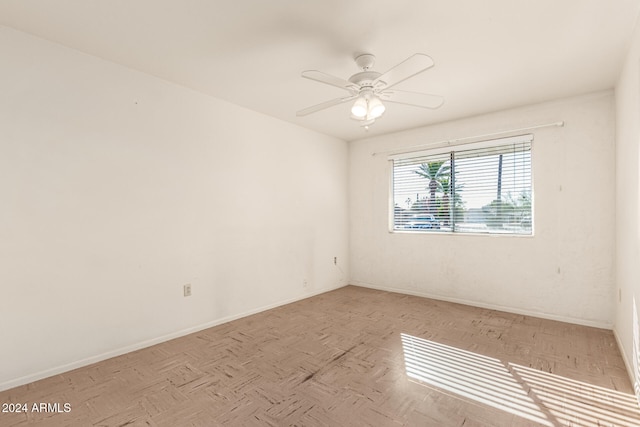 unfurnished room with ceiling fan and light parquet flooring