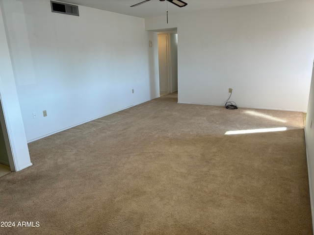 unfurnished room with ceiling fan and light colored carpet