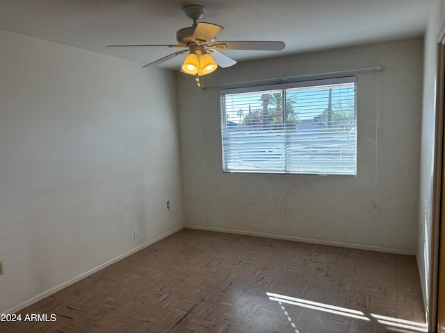 unfurnished room with light parquet flooring and ceiling fan