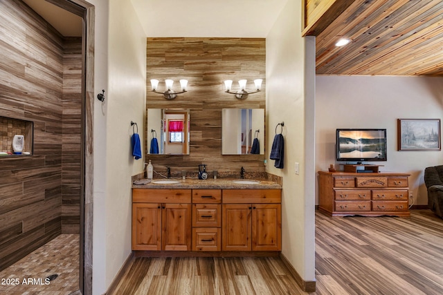 2352 Immelman Cir, Overgaard, AZ 85933 - bathroom with wood finished floors, double vanity, baseboards, and a tile shower