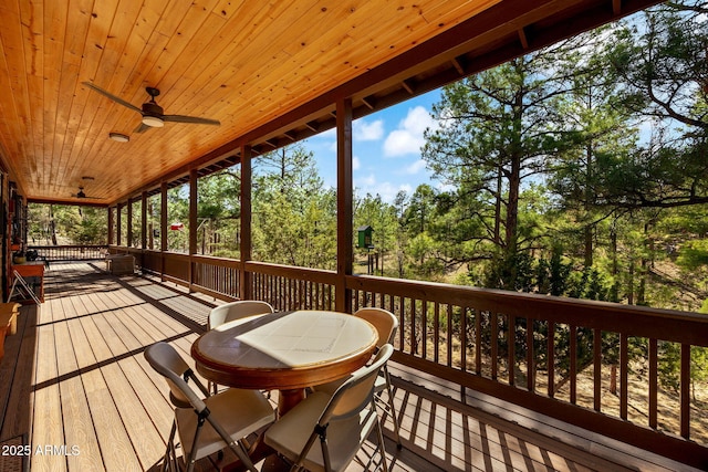 2352 Immelman Cir, Overgaard, AZ 85933 - wooden deck featuring ceiling fan, outdoor dining area, and view of wooded area