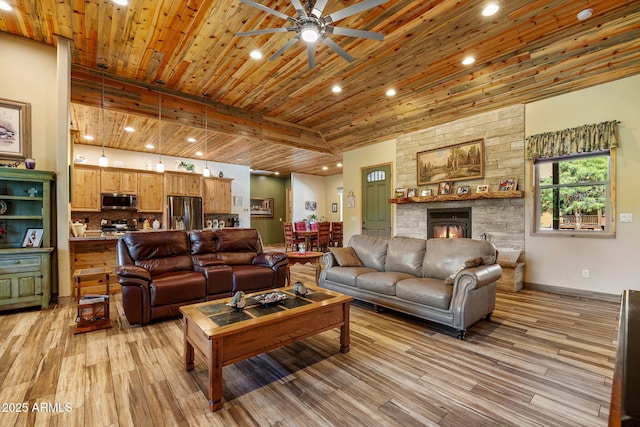 2352 Immelman Cir, Overgaard, AZ 85933 - living area featuring light wood finished floors, a ceiling fan, wood ceiling, recessed lighting, and a stone fireplace