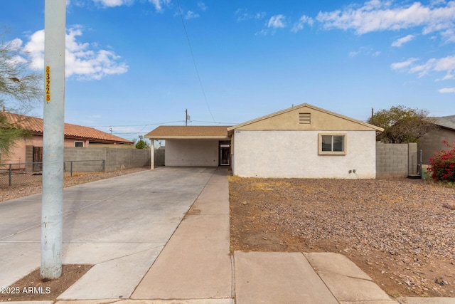 ranch-style house featuring a carport