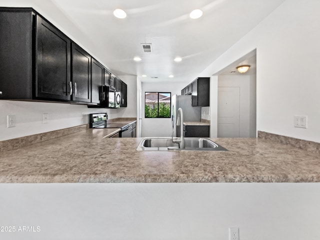 1953 W Stage Driver St, Apache Junction, AZ 85120 - kitchen featuring range with electric stovetop, dark cabinets, recessed lighting, and light countertops