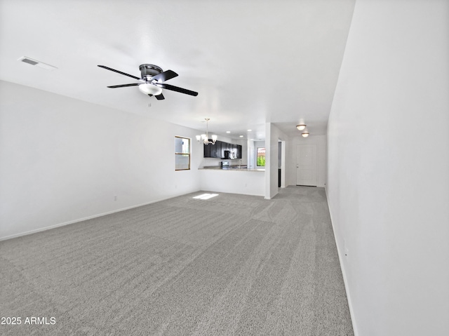 1953 W Stage Driver St, Apache Junction, AZ 85120 - unfurnished living room with a chandelier, light carpet, and a ceiling fan