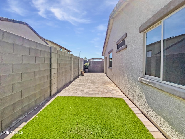 1953 W Stage Driver St, Apache Junction, AZ 85120 - fenced backyard with a patio